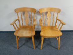 A pair of pine farmhouse kitchen armchairs