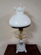 A 19th century cast iron based oil lamp with glass reservoir (as found),