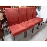 A set of six contemporary high backed dining chairs upholstered in a red suede fabric