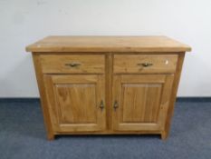 A contemporary oak double door sideboard fitted two drawers,