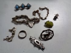 A box containing a quantity of silver jewellery to include heart locket on chain, assorted brooches,