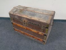 An early 20th century wooden bound dome topped shipping trunk