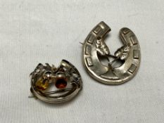 Two vintage silver horse shoe shaped brooches