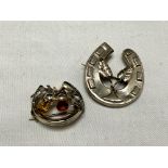 Two vintage silver horse shoe shaped brooches