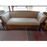 A late 19th century mahogany framed settee upholstered in a classical striped fabric
