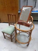 An Edwardian oak bedroom chair together with a dressing table vanity mirror and a circular bamboo
