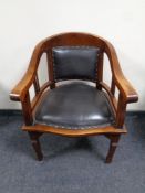 A mahogany armchair upholstered in a black leather