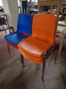 Five Norwegian moulded plastic stacking chairs on metal legs