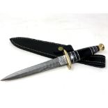 A commando style knife with Damascus steel blade,