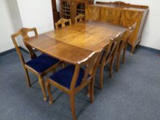 An eight piece walnut Queen Anne style dining room suite : shaped sideboard, extending table,