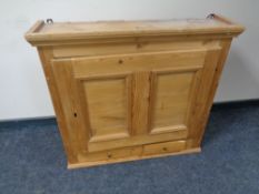 An antique pine wall cupboard fitted two drawers