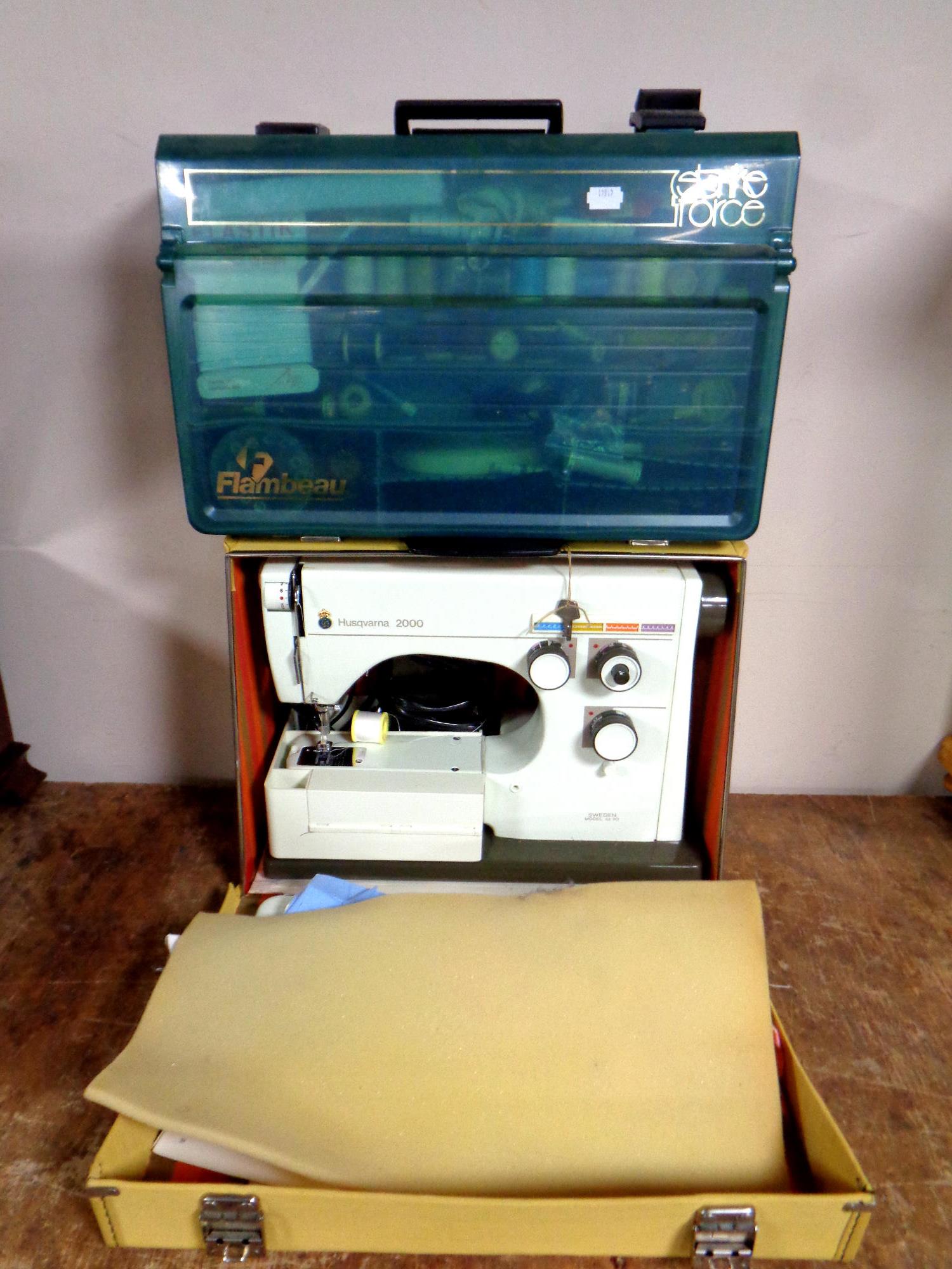 A Husqvarna 2000 electric sewing machine in case (continental wiring) together with a plastic case