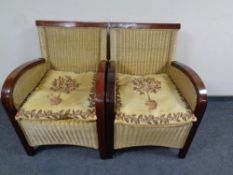 A pair of wood and wicker conservatory armchairs