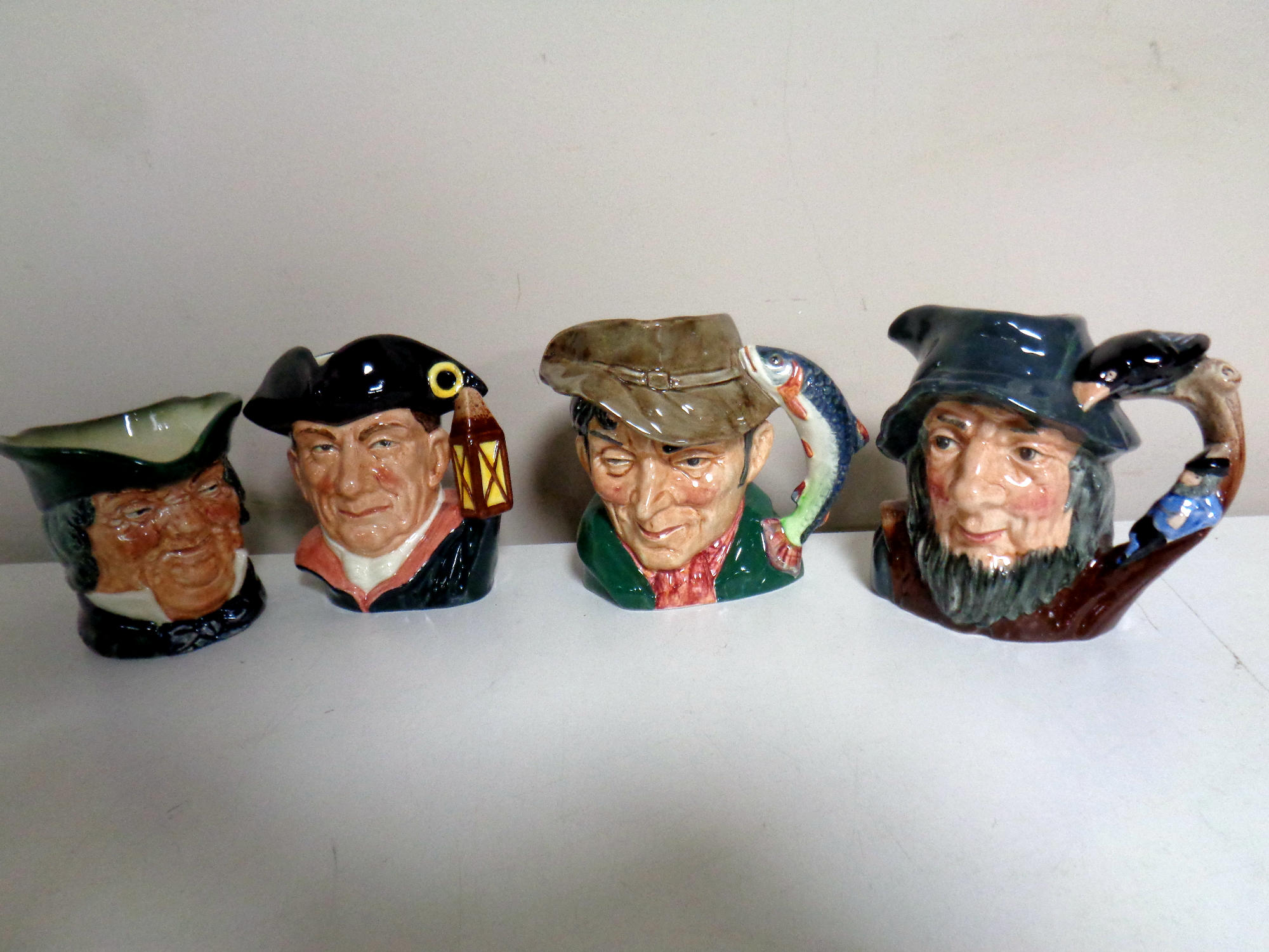 Four small Royal Doulton character jugs - The Poacher, Rip Van Winkle,