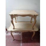 A nest of two shaped blonde oak tables
