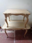 A nest of two shaped blonde oak tables