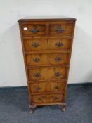 A Burton Reproductions Limited walnut seven drawer chest, width 47 cm,