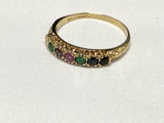 A 9ct gold ring with coloured gemstones, spelling the word 'Dearest', size R, 1.