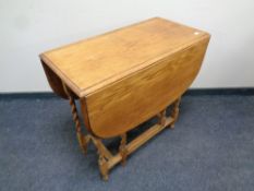 A 20th century oak barley twist gate leg table
