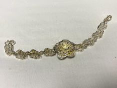 A floral filigree style white metal bracelet