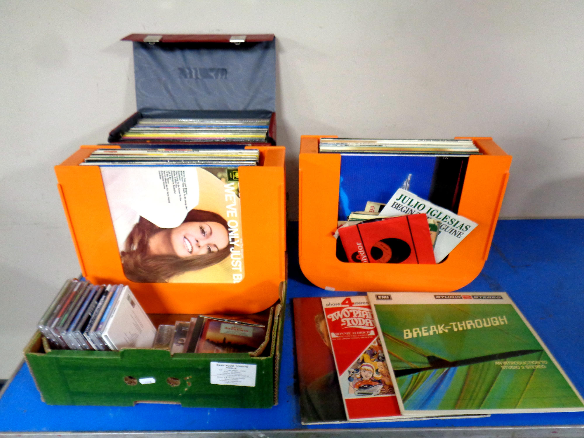 A case and two plastic racks containing a quantity of vinyl LPs to include compilations etc