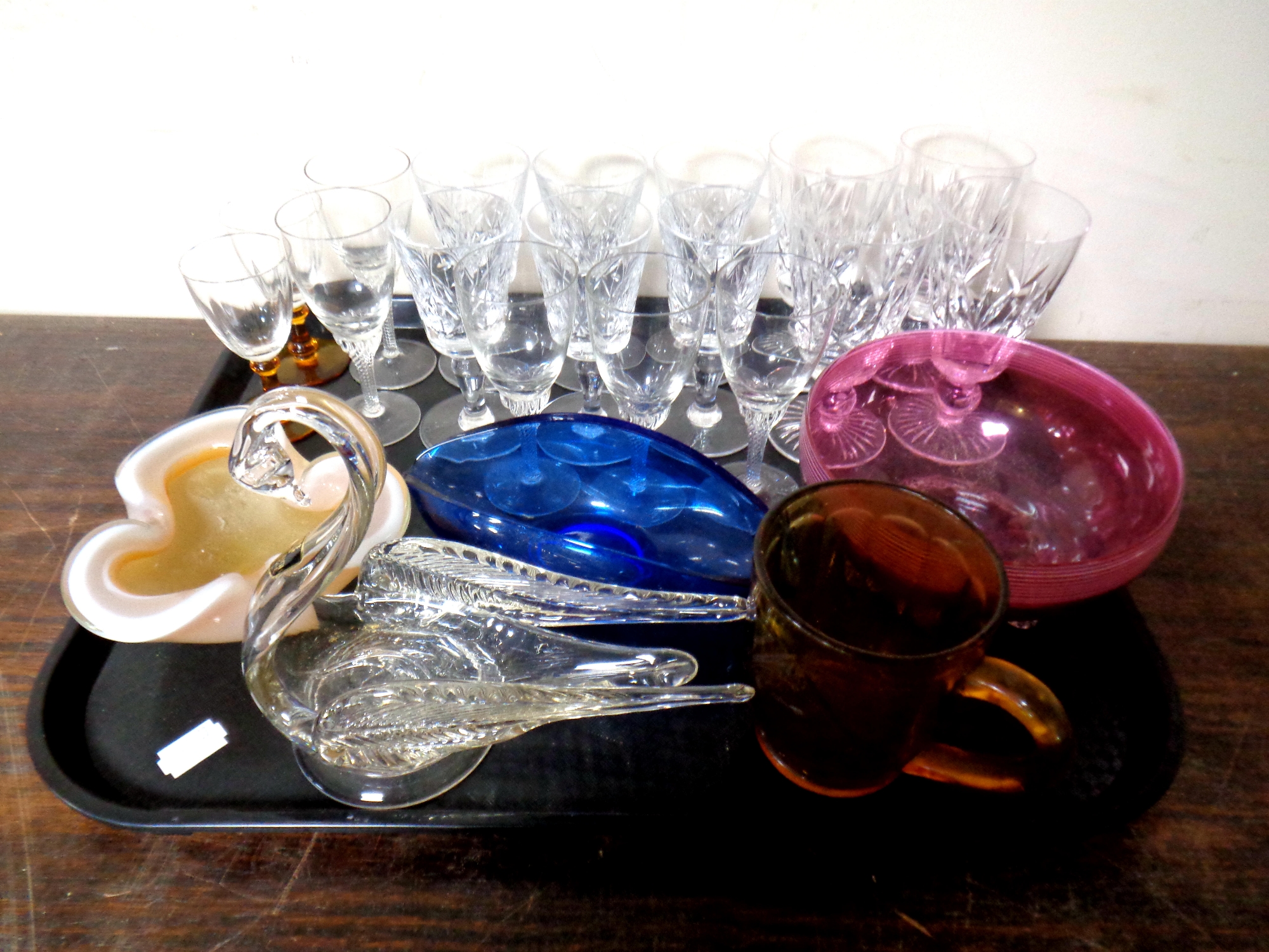 A tray containing assorted glassware to include liqueur glasses, Art Glass ashtray,