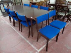 A 20th century twin pedestal extending dining table with leaf together with a set of eight chairs
