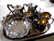 A silver plated serving tray containing plated tea wares, tankard,