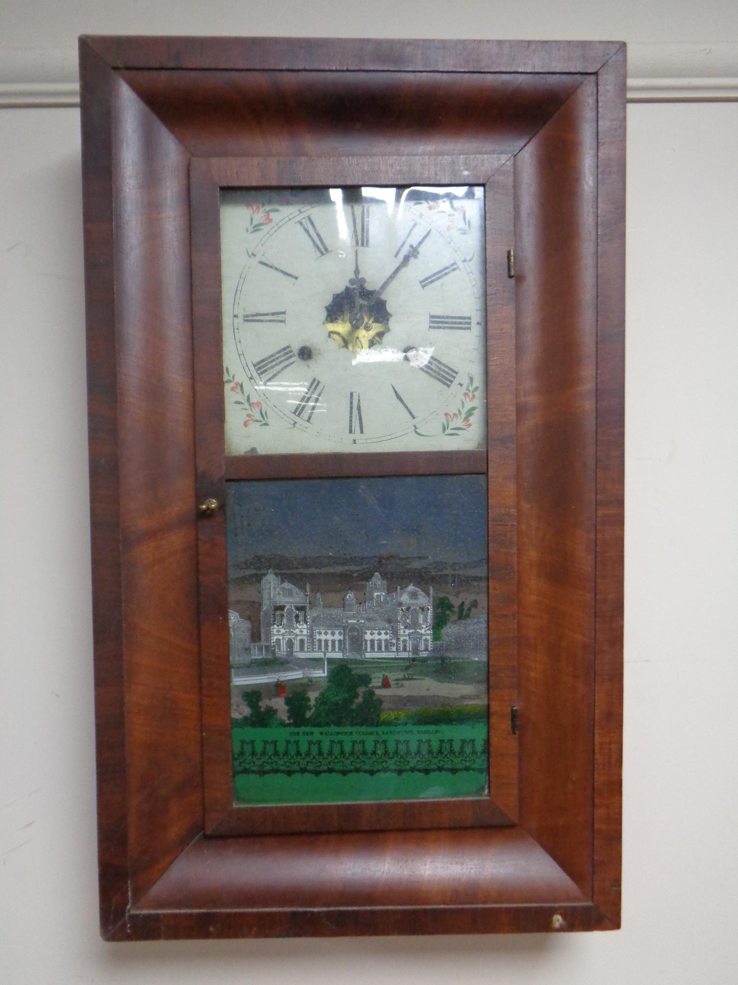 An antique American Jerome and Company 30 hour wall clock with glass panel depicting The New