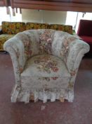 A 20th century tub chair upholstered in a floral fabric