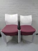 A set of eight moulded plastic and Burgundy fabric stacking office chairs