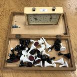 A chessboard and pieces together with a chess clock.
