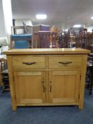 A contemporary oak double door sideboard fitted two drawers