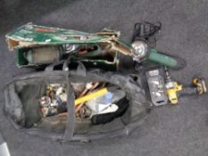 A plumber's bag containing brass fittings together with a Bosch sander, grinder, De Walt drill,