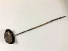 A silver toddy ladle with turned wooden handle