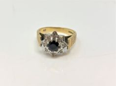 An 18ct yellow gold sapphire cluster ring set with small diamond chips, size N, 5.5g.