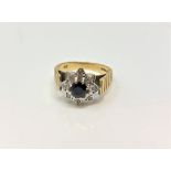 An 18ct yellow gold sapphire cluster ring set with small diamond chips, size N, 5.5g.