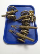 A tray of five brass cannon ornaments
