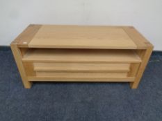 A contemporary oak television stand fitted a drawer