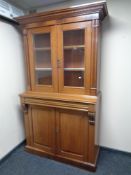 A Victorian mahogany double door glazed bookcase fitted cupboard and drawer beneath