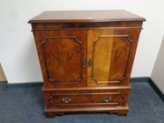 A reproduction burr elm television cabinet