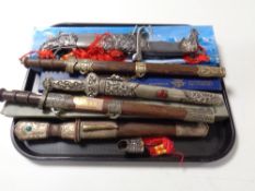 A tray containing a quantity of boxed and unboxed replica oriental and Persian style knives