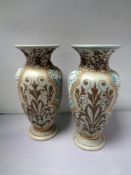 A pair of 19th century Royal Doulton pottery vases, height 19.7 cm, initialled M.M.R.