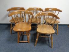 A set of four beech dining armchairs together with one other similar chair