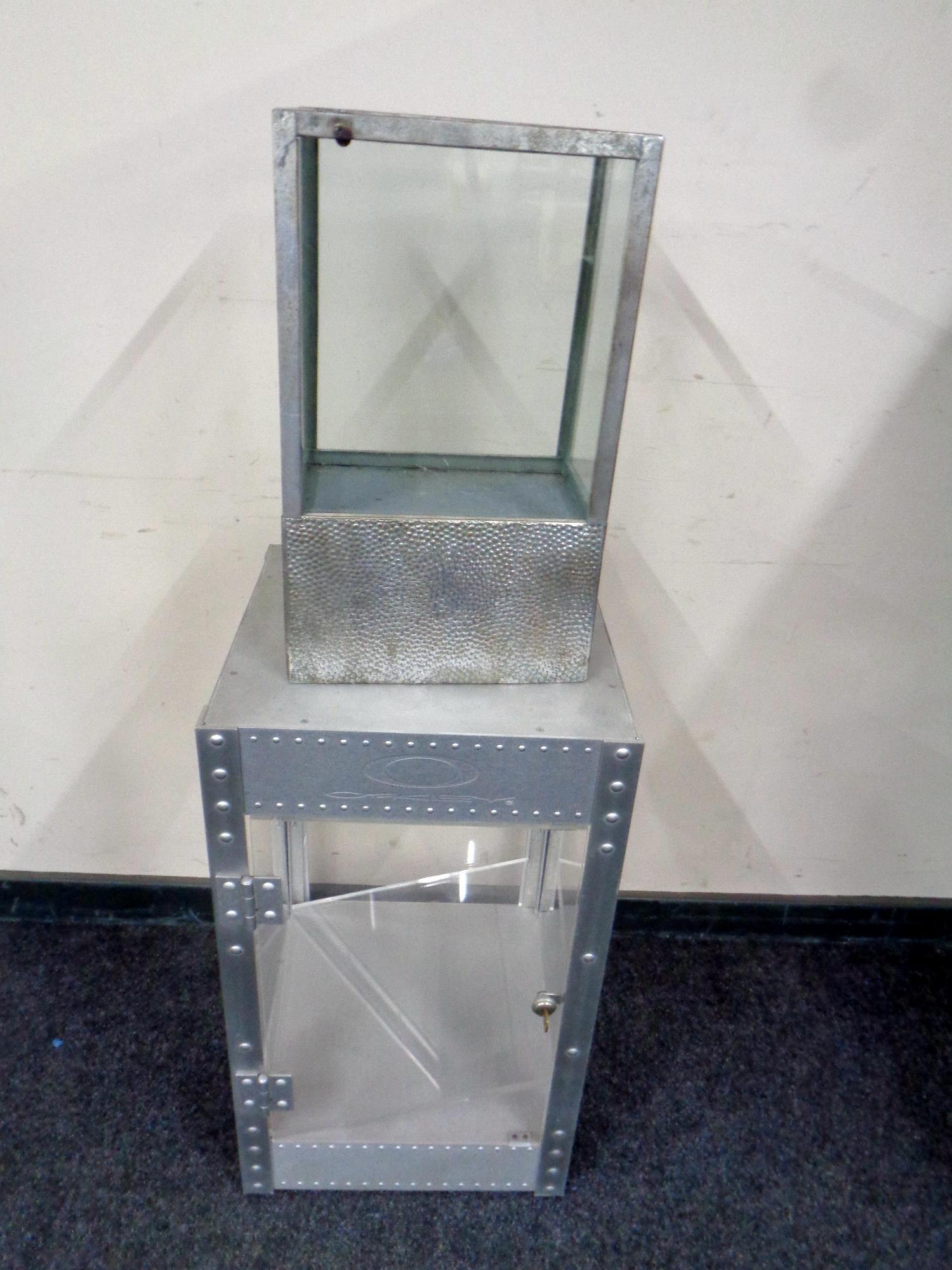 An Oakley metal framed counter top display cabinet together with a further Broste metal framed