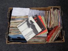 A box containing a large quantity of vinyl seven inch singles to include AC DC, Foreigner,