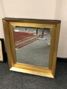 A contemporary golden framed mirror,