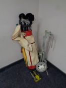 A set of McGregor golf clubs in bag with folding golf trolley and box of Donnay golf balls
