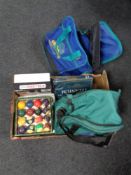 A box containing two bowling bags containing three bowling balls, three sets of pool balls,