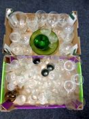 Two boxes containing a large quantity of assorted glassware to include drinking glasses,